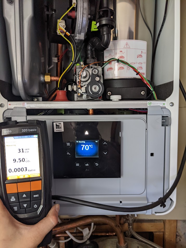 NicHall engineer using a combustion analyser to tune a gas boiler